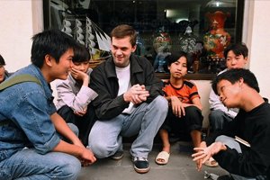 founder sitting with a group of kids
