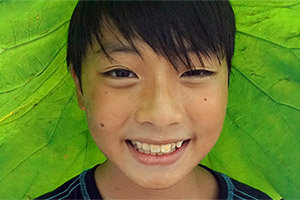Boy with leaf covering his head